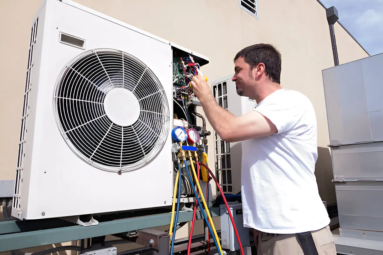 Home 11 HVAC technician performing emergency AC repair at night in Bonita Springs